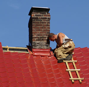 Builder working on a chimney : � Radoslaw Kostka | Dreamstime.com 